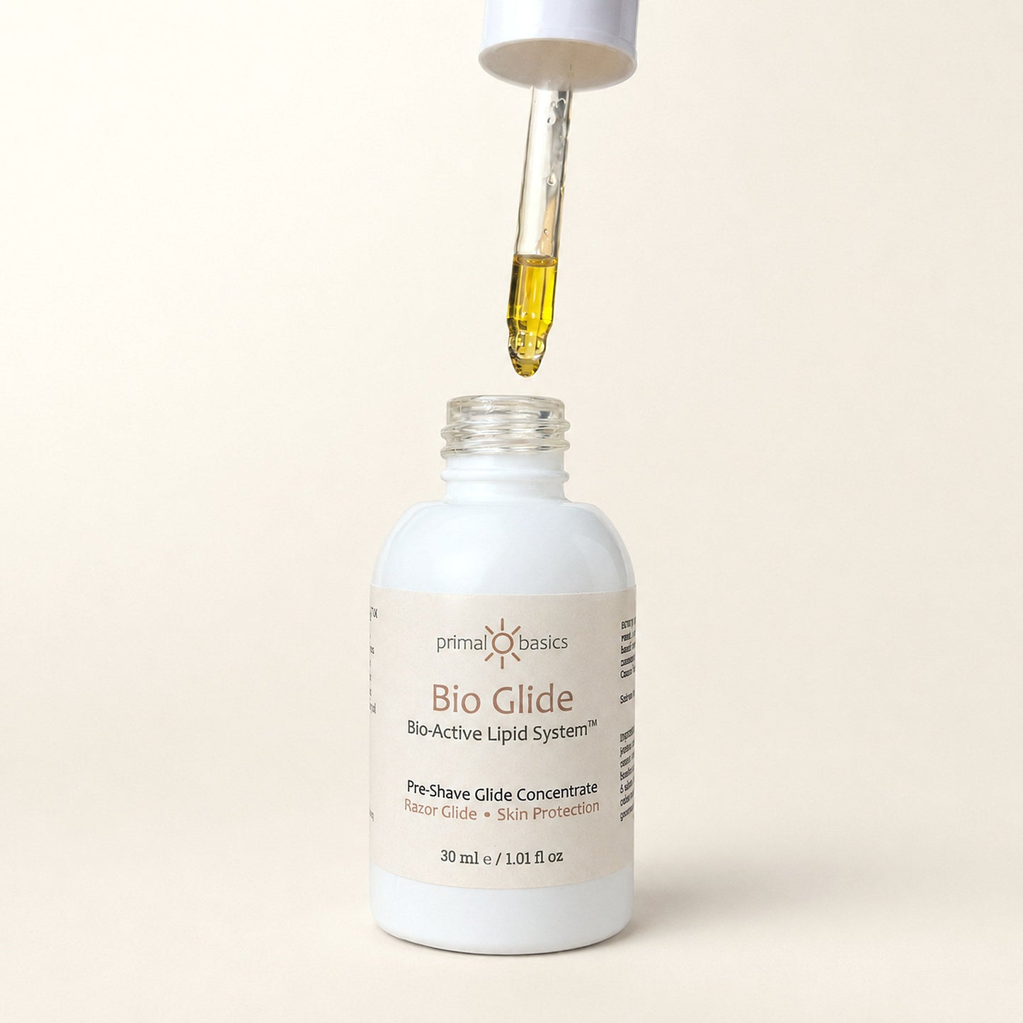 Bio Glide dropper releasing a golden oil droplet above the bottle