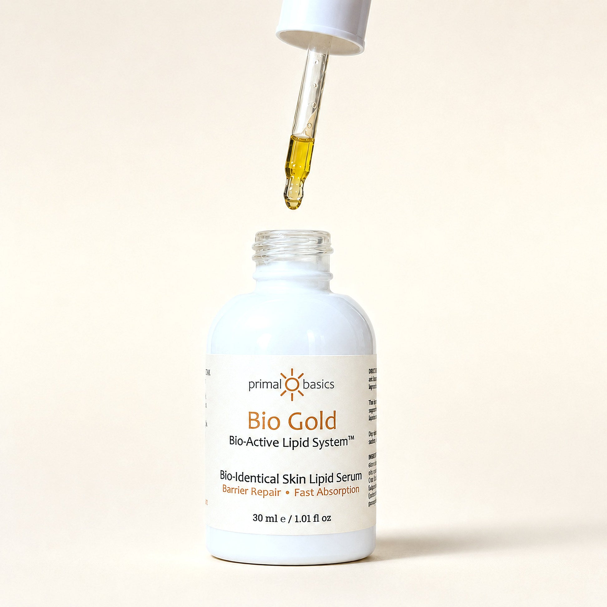 Bio Gold serum dropper releasing a golden oil droplet above the bottle
